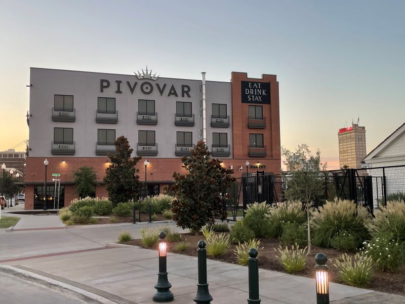 Pivovar Hotel Waco exterior view with lush surroundings.