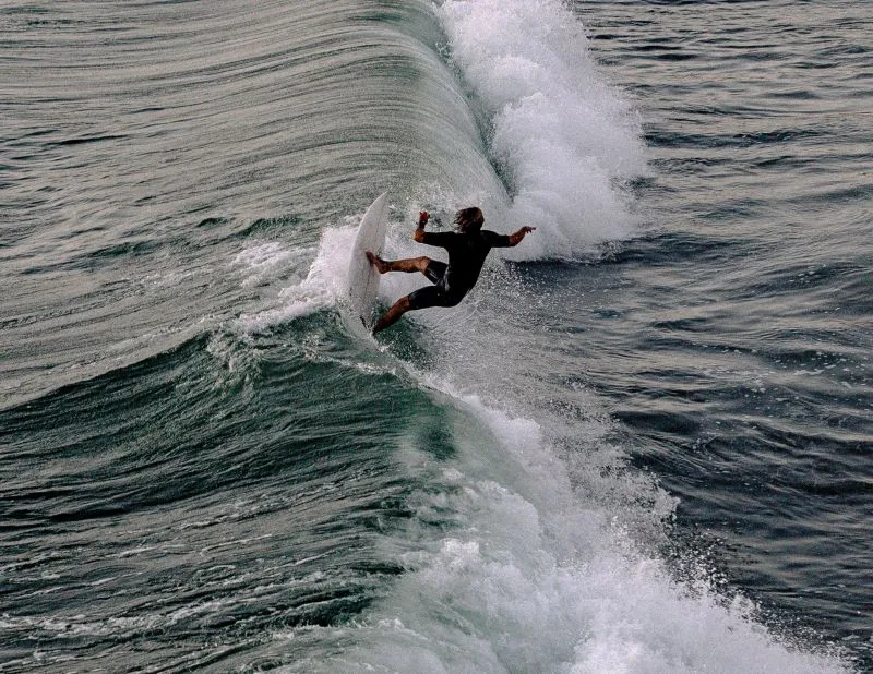 Skilled surfer conquering a challenging wave at Waco Surf Experience.