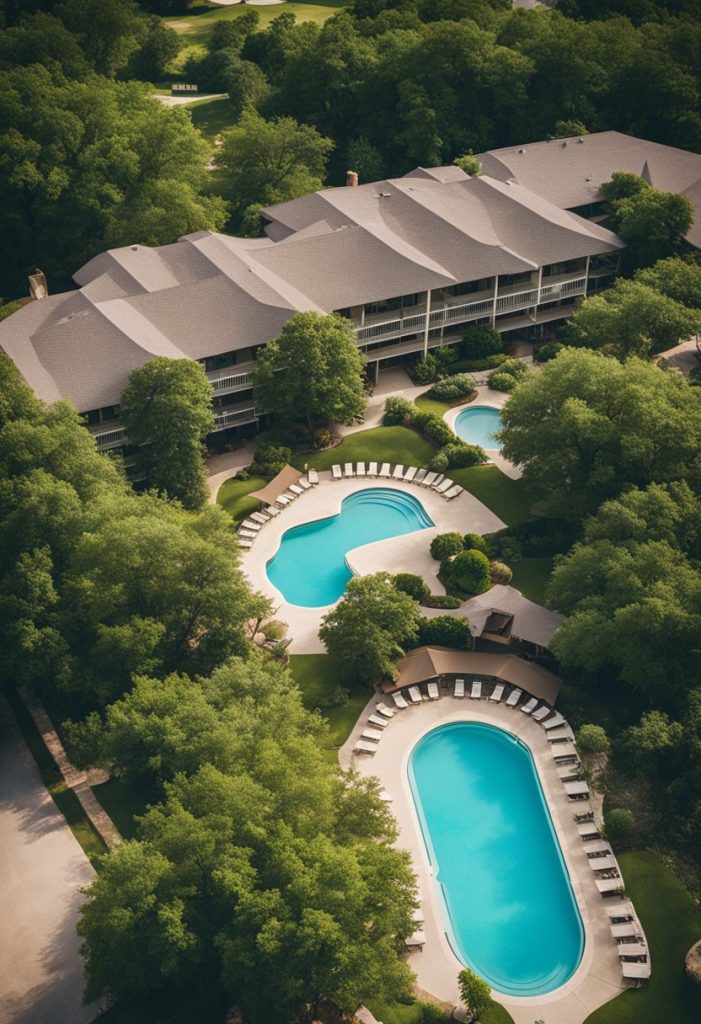 Aerial view of Super 8 Waco surrounded by lush greenery, with a sparkling swimming pool and a row of neatly lined up guest rooms
