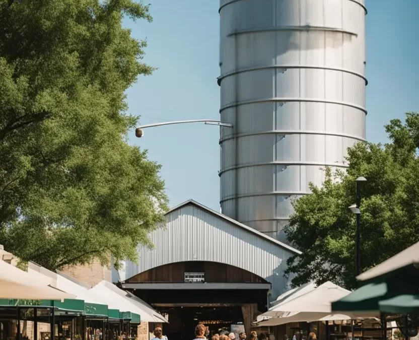 The bustling Magnolia Market at the Silos in Waco, Texas: Your Ultimate Guide to a Charming Destination, with its iconic grain silos and charming storefronts, surrounded by lush greenery and cheerful visitors.