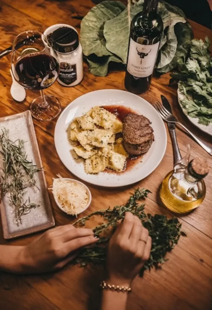 Steak served with a glass of wine at one of the Top Restaurants to Eat This December in Waco Texas