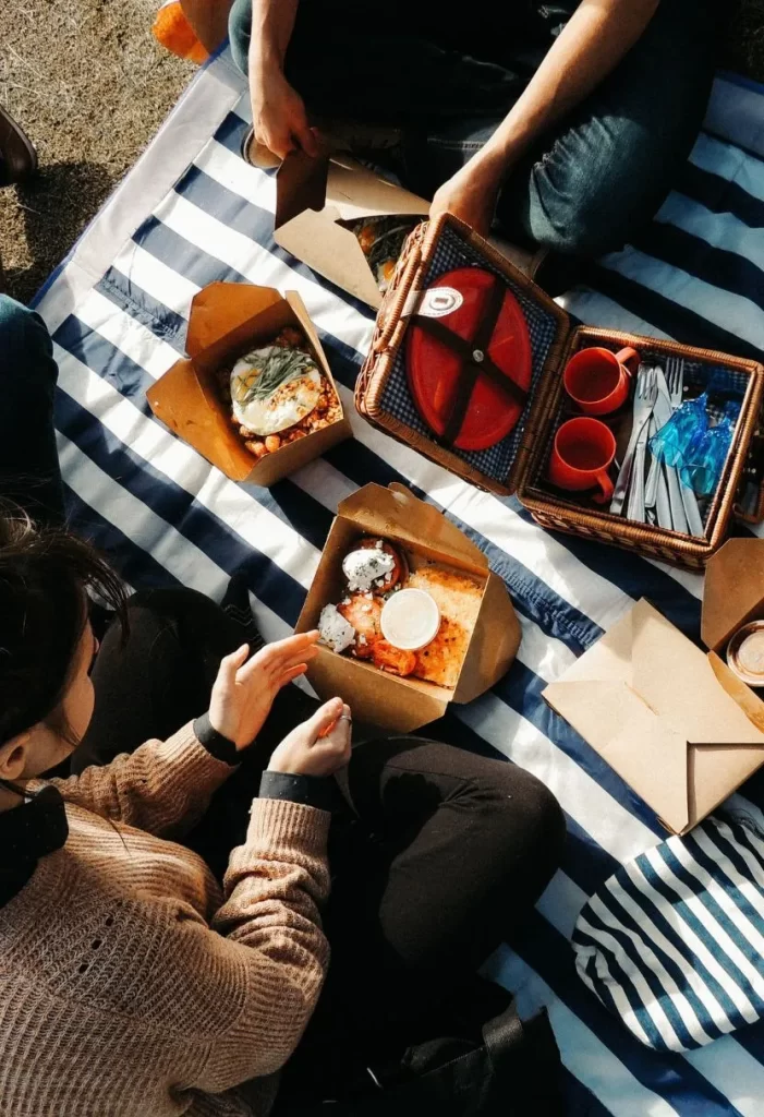 Friends enjoying their food in one of the Top 10 Picnic Parks in Waco, Texas.