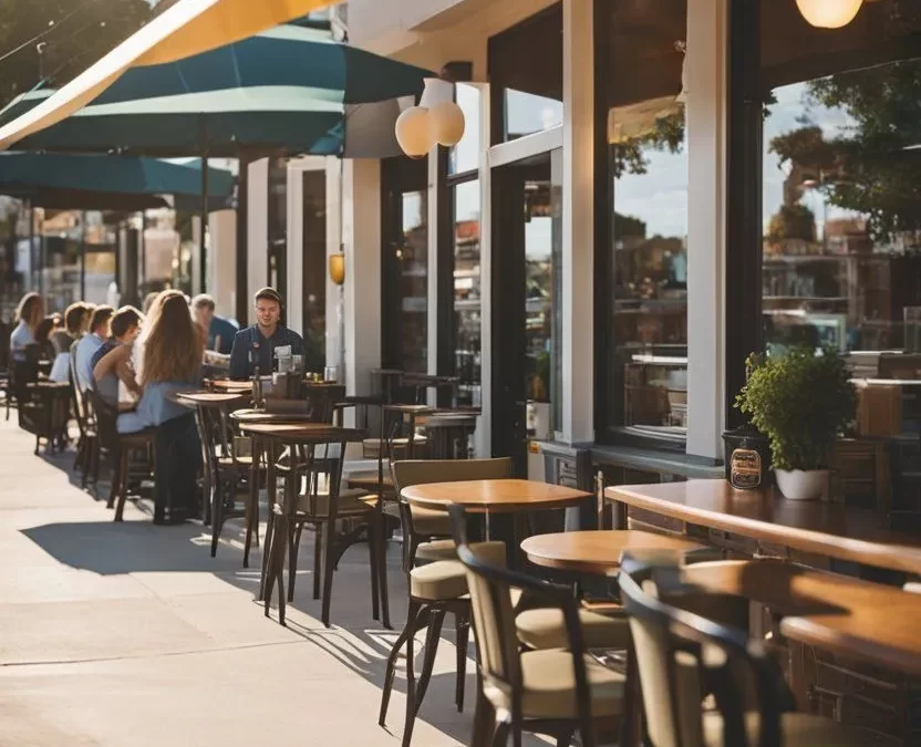 A bustling breakfast cafe in Waco, Texas, with outdoor seating, colorful signage, and a line of locals waiting to enjoy their favorite morning dishes. One of the 10 Best Breakfast Spots in Waco, Texas.